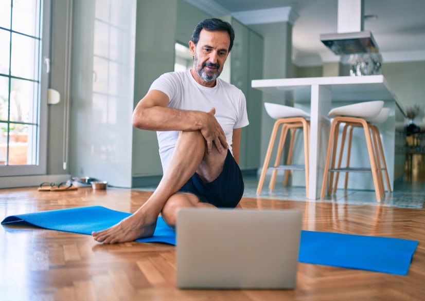 man stretching on yoga mat