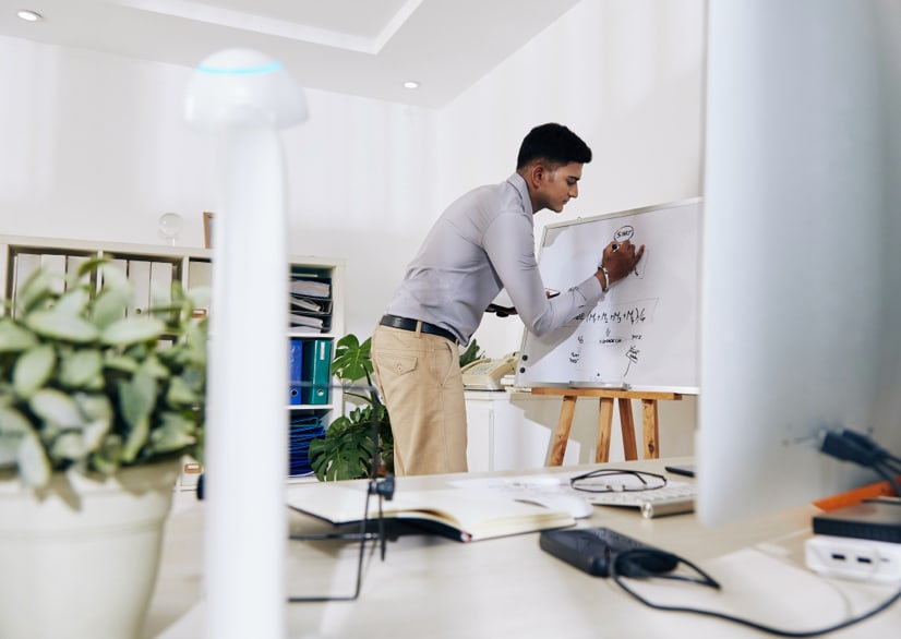 man writing on whiteboard